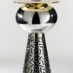 <p><strong><a href=ettore-sottsass.html class=link-lightbox>Ettore Sottsass</a></strong><br />Bharata</p><p><strong>German Silver</strong><br />Flower vase in silver and gold-plated brass with hand-made inlay.<br />d.26 x h. 51 cm.</p>