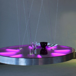 <p><strong><a href=johanna-grawunder.html class=link-lightbox>Johanna Grawunder</a></strong><br />In the Desert</p><p><strong>Puddle</strong><br />Luminous round table  in polished aluminium structure and colored Perspex top. Suspension from  ceiling by adjustable steel cables. Internal lighting system with 8 fluorescent  tubes.<br />  d. 128 cm.</p><p>Limited edition of 6 signed and numbered  pieces.</p>